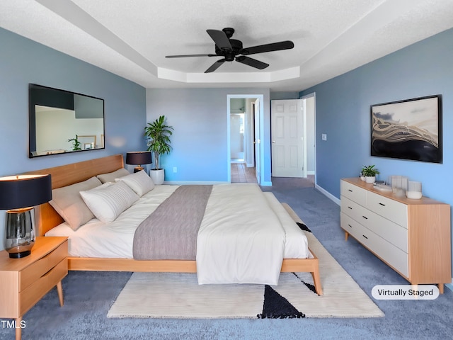 357 Riverwood Dr, Clayton, NC 27527 - bedroom with ensuite bathroom, baseboards, ceiling fan, a raised ceiling, and carpet floors