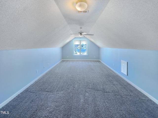 357 Riverwood Dr, Clayton, NC 27527 - bonus room with vaulted ceiling, carpet flooring, a textured ceiling, baseboards, and visible vents