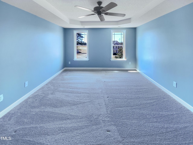 357 Riverwood Dr, Clayton, NC 27527 - spare room with baseboards, a textured ceiling, a raised ceiling, carpet floors, and ceiling fan