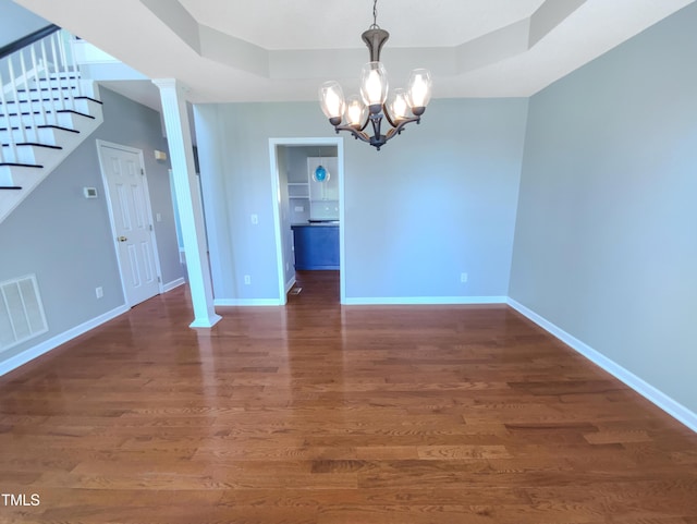 357 Riverwood Dr, Clayton, NC 27527 - unfurnished dining area featuring stairway, baseboards, a chandelier, visible vents, and wood finished floors