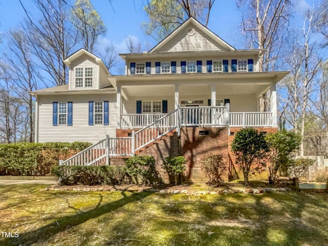 view of front facade featuring stairs and covered porch
