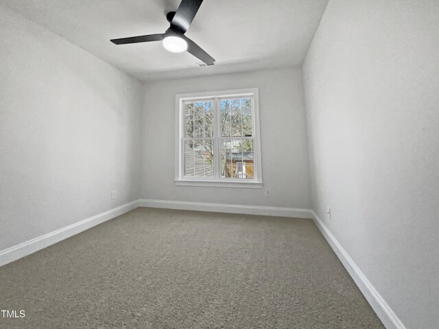 unfurnished room with a ceiling fan, carpet floors, and baseboards