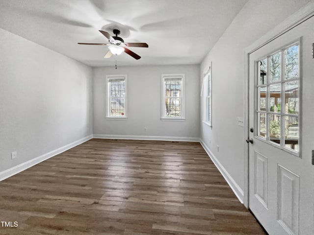 foyer with baseboards, ceiling fan, and dark wood-style flooring