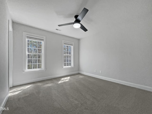 unfurnished room with baseboards, visible vents, ceiling fan, and carpet floors