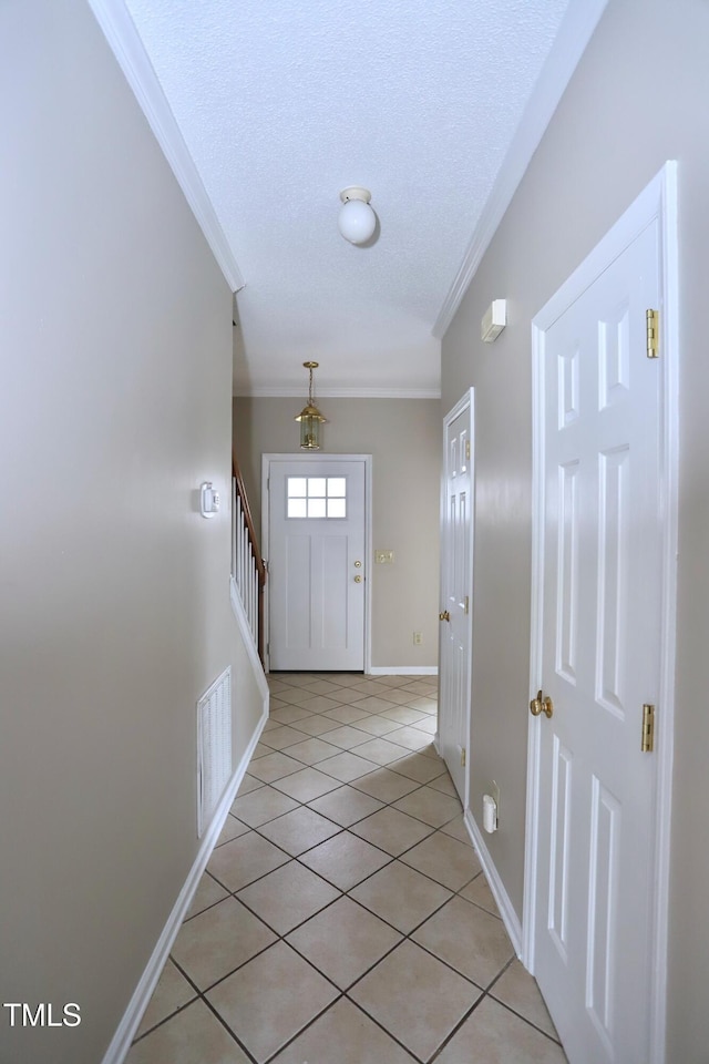 3313 Sparrowhawk Dr, High Point, NC 27265 - entryway with baseboards, ornamental molding, light tile patterned floors, a textured ceiling, and visible vents