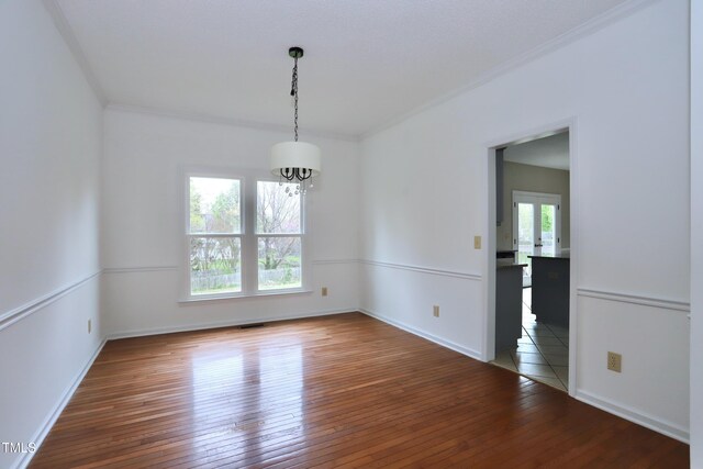 3313 Sparrowhawk Dr, High Point, NC 27265 - unfurnished dining area with crown molding, visible vents, a chandelier, wood-type flooring, and baseboards