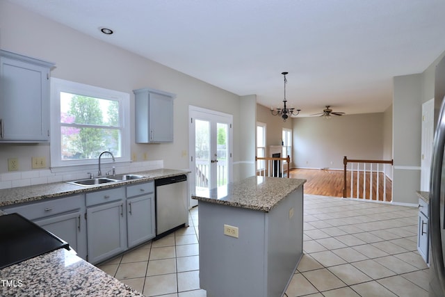 3313 Sparrowhawk Dr, High Point, NC 27265 - kitchen featuring stainless steel dishwasher, light tile patterned floors, a sink, and a kitchen island