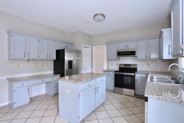 3313 Sparrowhawk Dr, High Point, NC 27265 - kitchen featuring decorative backsplash, appliances with stainless steel finishes, light tile patterned floors, and a sink