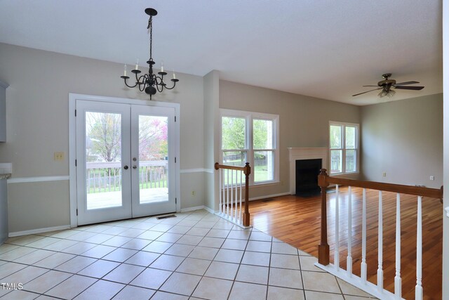 3313 Sparrowhawk Dr, High Point, NC 27265 - entryway featuring baseboards, light tile patterned floors, french doors, a fireplace with flush hearth, and visible vents
