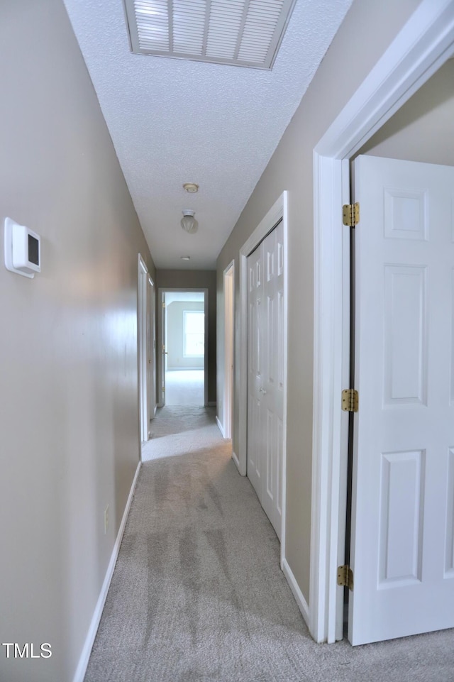 3313 Sparrowhawk Dr, High Point, NC 27265 - hallway with carpet flooring, visible vents, a textured ceiling, and baseboards