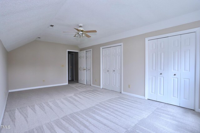 3313 Sparrowhawk Dr, High Point, NC 27265 - unfurnished bedroom with baseboards, vaulted ceiling, a textured ceiling, visible vents, and multiple closets