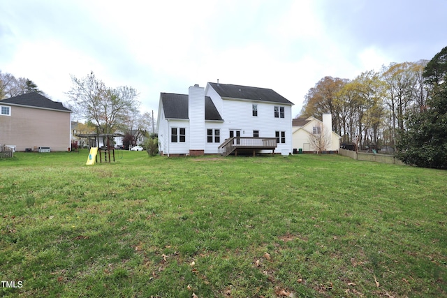 3313 Sparrowhawk Dr, High Point, NC 27265 - back of property with a deck, a chimney, a playground, and a lawn