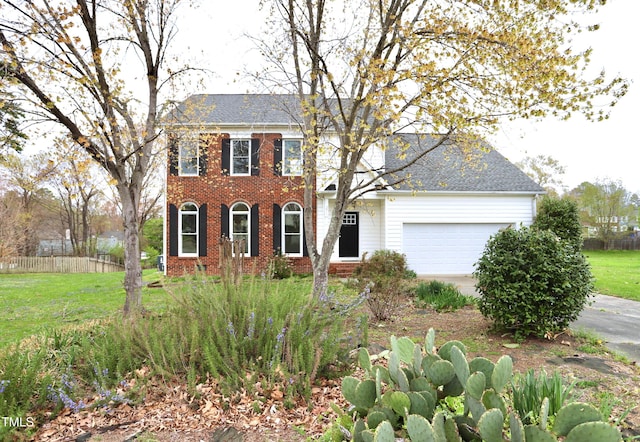 3313 Sparrowhawk Dr, High Point, NC 27265 - colonial-style house featuring brick siding, a front lawn, fence, and a garage