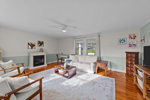 116 Lakewood Dr, Wendell, NC 27591 - living room with baseboards, ceiling fan, visible vents, a fireplace, and wood finished floors