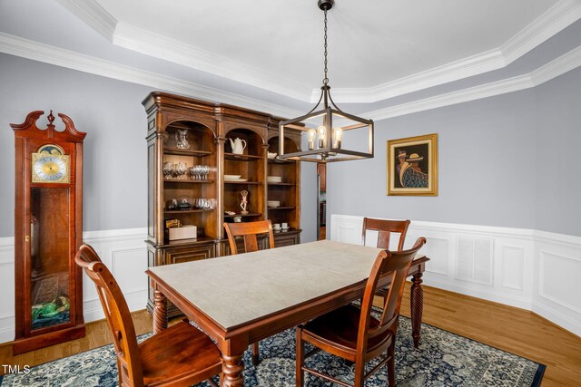 1808 Pattersons Mill Rd, Durham, NC 27703 - dining area with visible vents, a chandelier, a tray ceiling, wainscoting, and wood finished floors