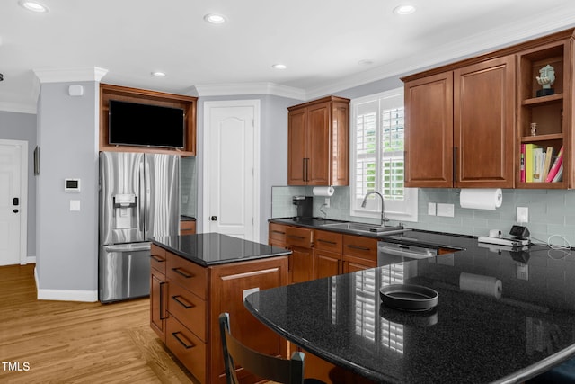 1808 Pattersons Mill Rd, Durham, NC 27703 - kitchen featuring dark stone countertops, a sink, appliances with stainless steel finishes, light wood-style floors, and crown molding