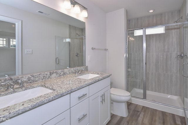 full bathroom with visible vents, a sink, toilet, and a shower stall