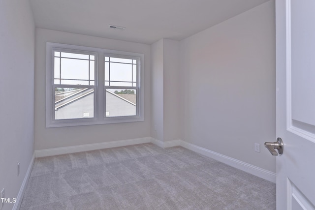 carpeted empty room with baseboards and visible vents