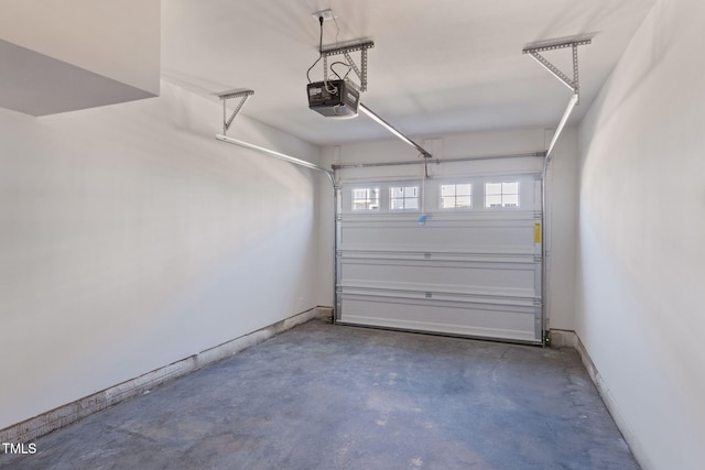 garage with baseboards and a garage door opener