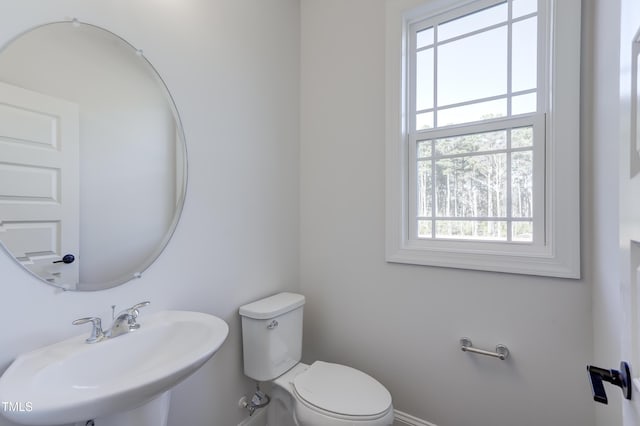half bathroom with toilet and a sink
