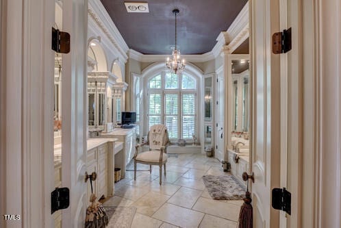 bathroom with an inviting chandelier, tile patterned floors, and ornamental molding