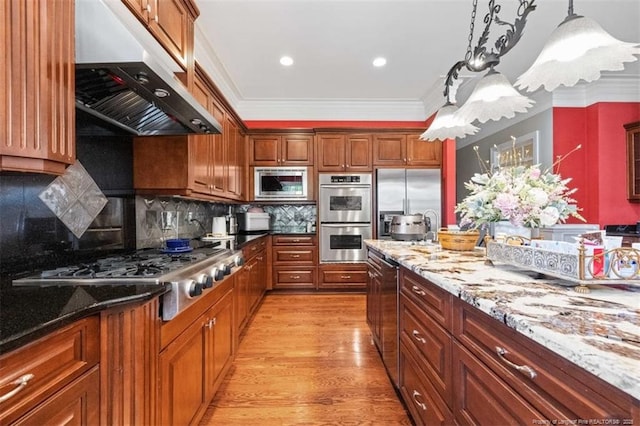 kitchen featuring crown molding, appliances with stainless steel finishes, under cabinet range hood, stone counters, and light wood-type flooring
