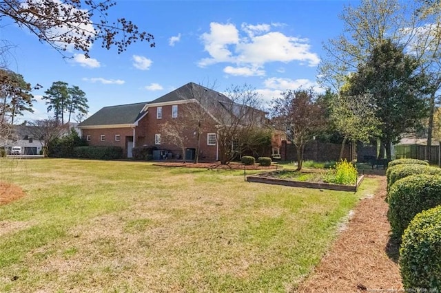 view of yard with a garden and fence