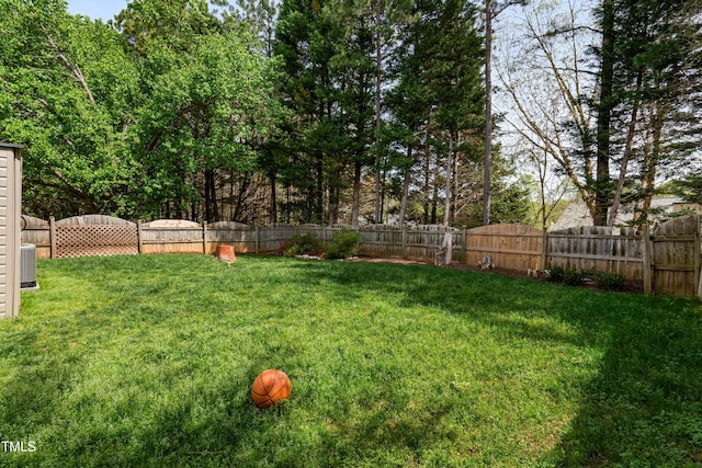 view of yard featuring central air condition unit and a fenced backyard