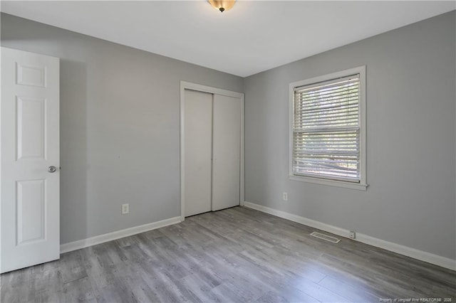 3722 Sandra Dr, Fayetteville, NC 28304 - unfurnished bedroom with visible vents, baseboards, and wood finished floors