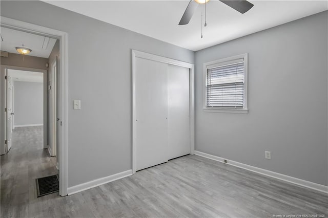 3722 Sandra Dr, Fayetteville, NC 28304 - unfurnished bedroom with a closet, visible vents, baseboards, wood finished floors, and attic access