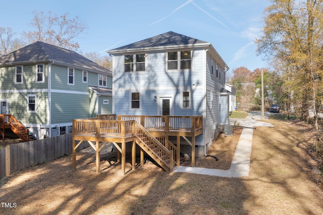 back of property with central air condition unit, fence, a wooden deck, and stairway