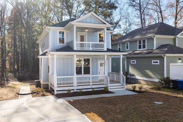 view of front of house with board and batten siding, a balcony, a ceiling fan, a porch, and a shingled roof