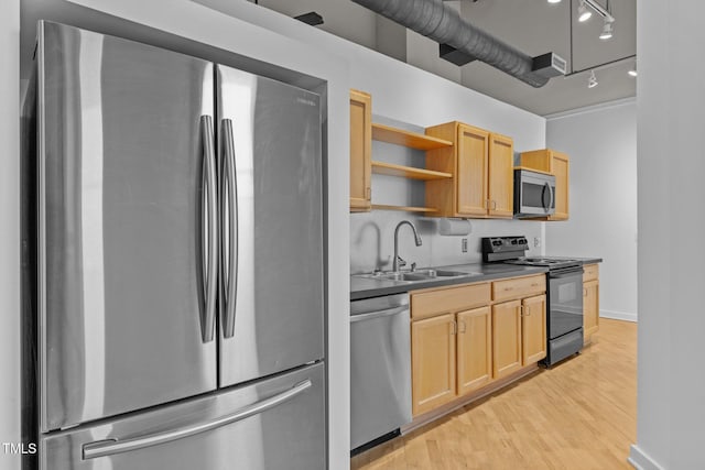 kitchen with open shelves, a sink, light wood-type flooring, appliances with stainless steel finishes, and dark countertops