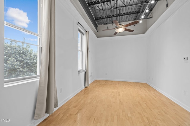 spare room with baseboards, a ceiling fan, and wood finished floors