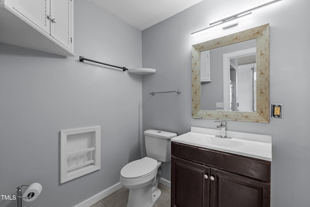 bathroom with tile patterned floors, vanity, baseboards, and toilet