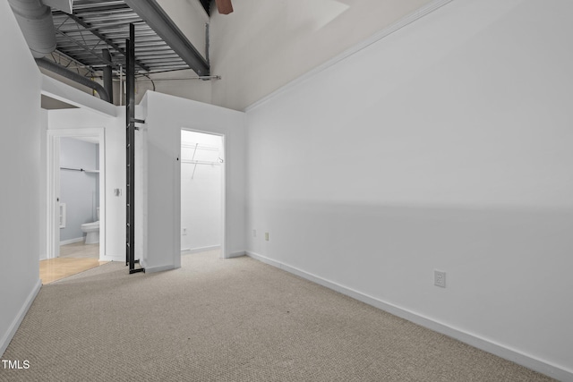 spare room featuring baseboards and carpet