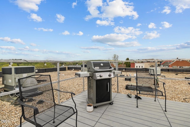 wooden terrace featuring grilling area and central air condition unit