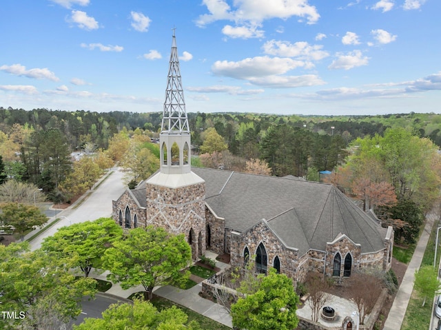 drone / aerial view featuring a wooded view