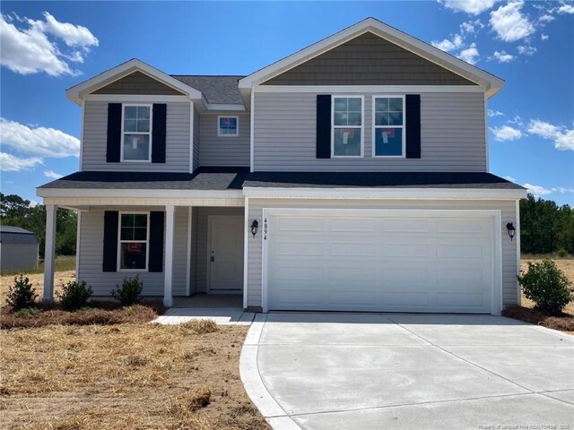 4894 Blue Springs Rd, Red Springs, NC 28377 - view of front of house with a porch, concrete driveway, an attached garage, and a shingled roof