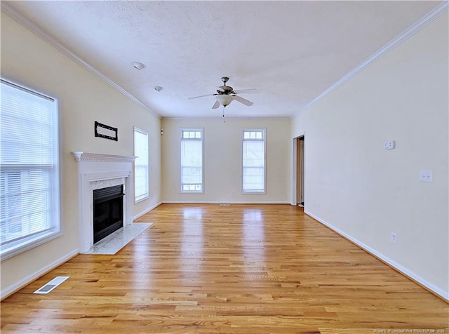 unfurnished living room featuring visible vents, ceiling fan, light wood-type flooring, and a fireplace