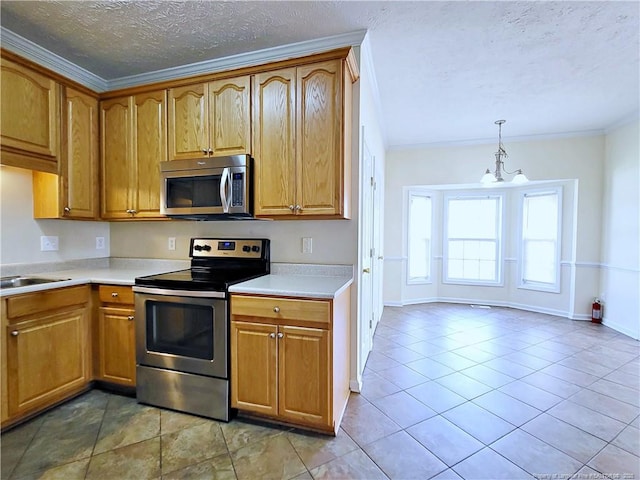 kitchen featuring light countertops, stainless steel appliances, crown molding, and a textured ceiling
