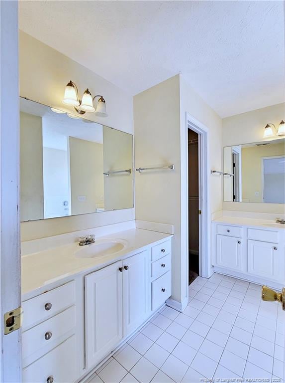 bathroom featuring tile patterned floors and vanity
