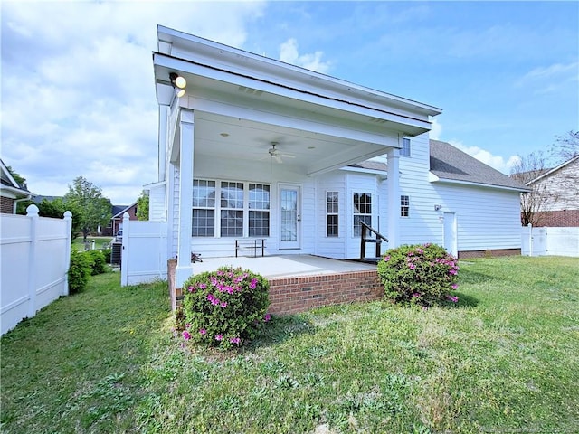 back of house with a patio, a lawn, fence, and ceiling fan