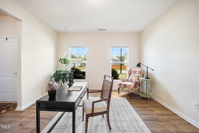 home office with wood finished floors and baseboards