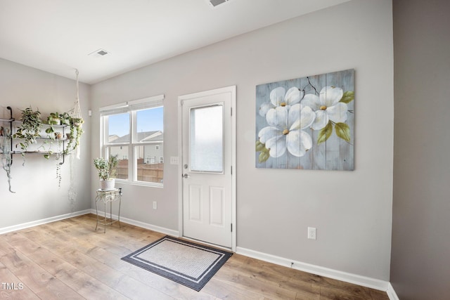 entryway with wood finished floors and baseboards