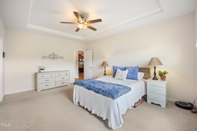 bedroom featuring a raised ceiling, carpet flooring, ceiling fan, and baseboards