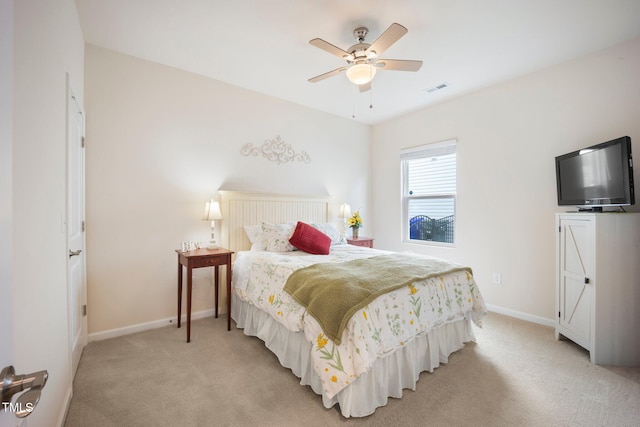 bedroom featuring light carpet, baseboards, and ceiling fan