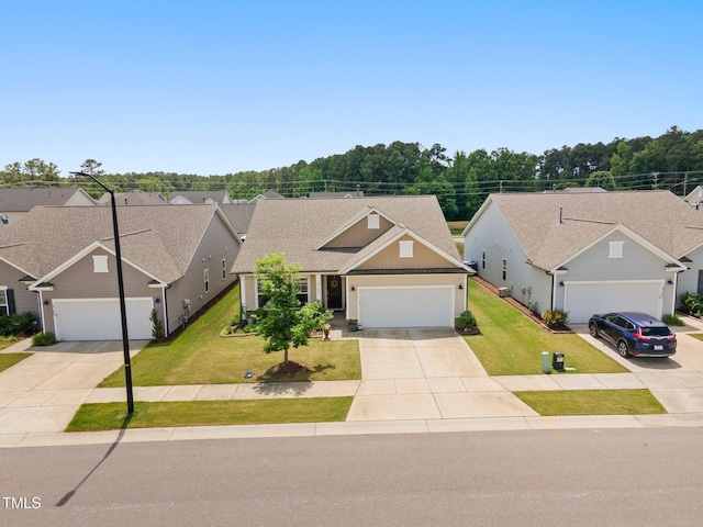 view of front of home with driveway, board and batten siding, a front yard, and a garage