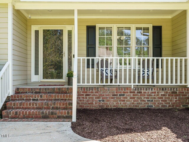 2213 Ravens Creek Ct, Raleigh, NC 27603 - doorway to property with a porch