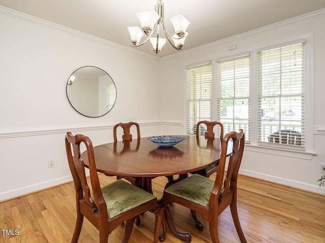 2213 Ravens Creek Ct, Raleigh, NC 27603 - dining area with light wood-style flooring, crown molding, an inviting chandelier, and baseboards
